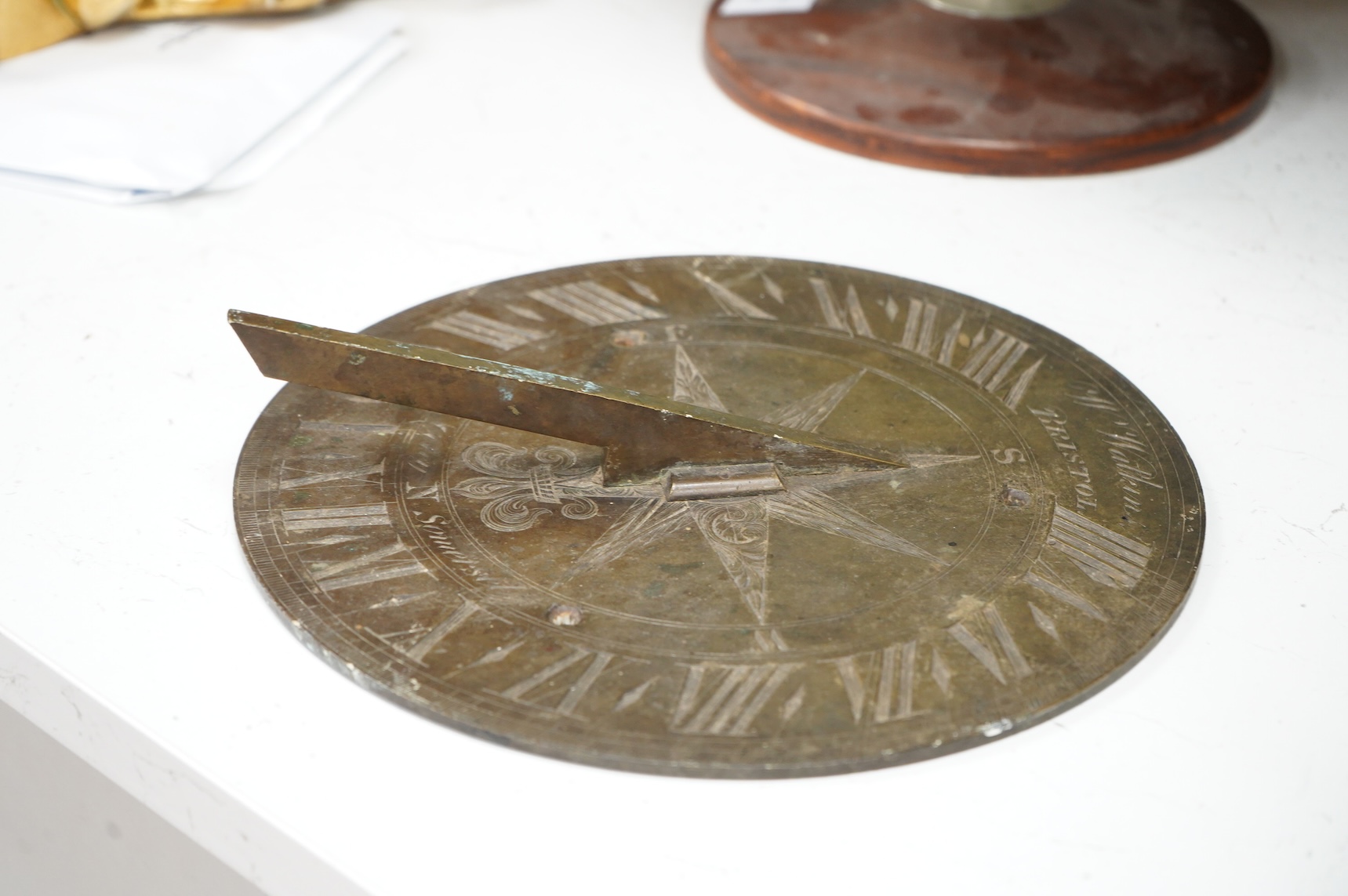 A William IV brass sundial, engraved W. Watkins, Bristol and J Coley, Somerset, 25cm in diameter, the low angle of the gnomon might indicate use in a tropical longitude